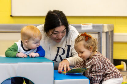 Jovanna Stipo, an assistant teacher in the Infant classroom at the TCELC reads to some of the children.  